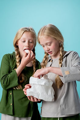 Two young girls eating marshmallows, demonstrating what self regulation might look like. 