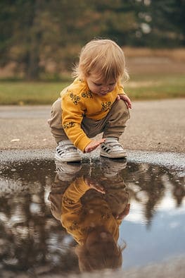 A child playing in a puddle