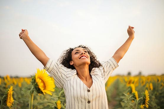 woman with arms raised in victory