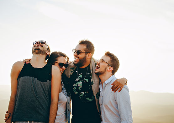A group of friends in a huddle, laughing