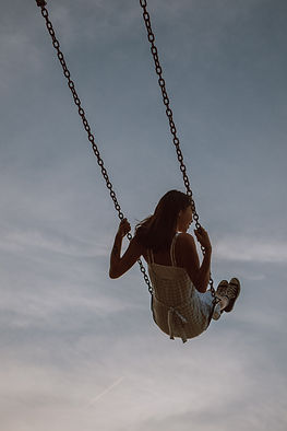 A woman swinging high, never concerned about saying "I lost my mojo!"