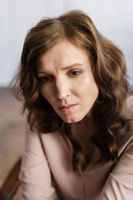 A woman looking dazed and anxious