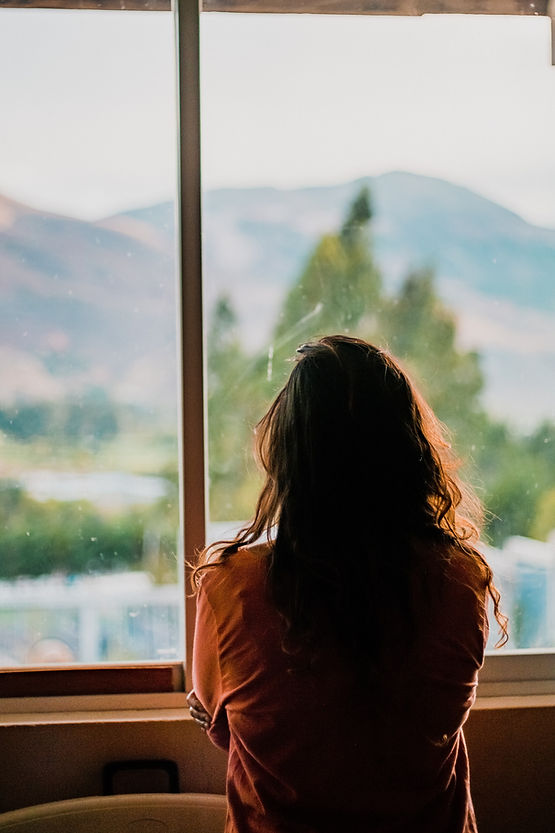 A person looking out a window