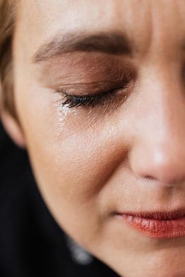 A woman's face showing tears and grief