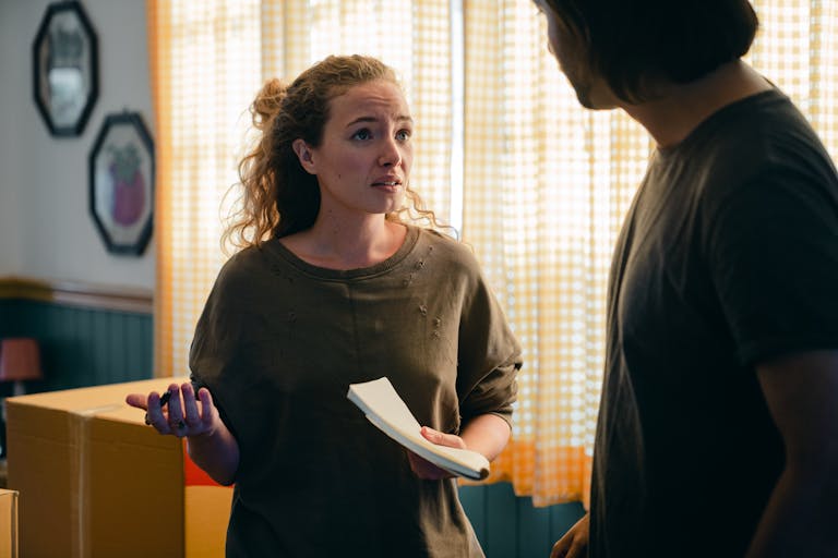 A couple engaged in a conversation while preparing to make a change