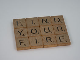 Scrabble pieces reading "find your fire" so you will never ask why do I have no motivation.