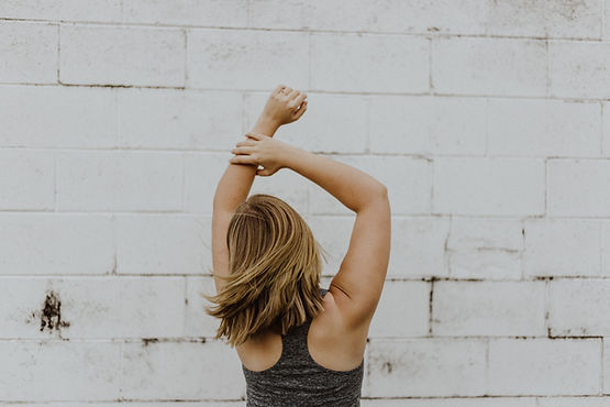 A person extending their arms above their head to stretch