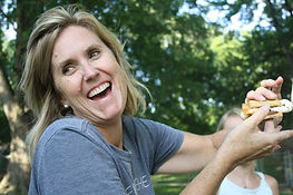 A woman laughing in a good mood because she's implementing mind-body nutrition strategies