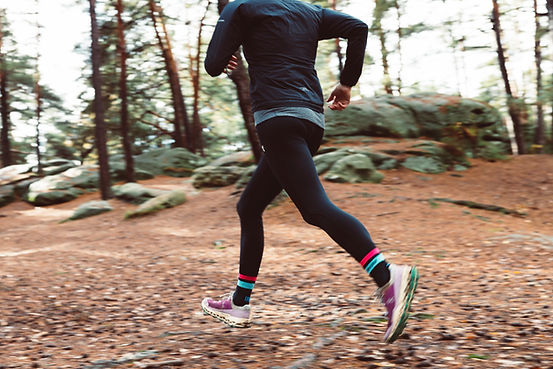 A woman running through the pain cave, approaching her menopause symptoms like an endurance athlete trained for mindset resilience