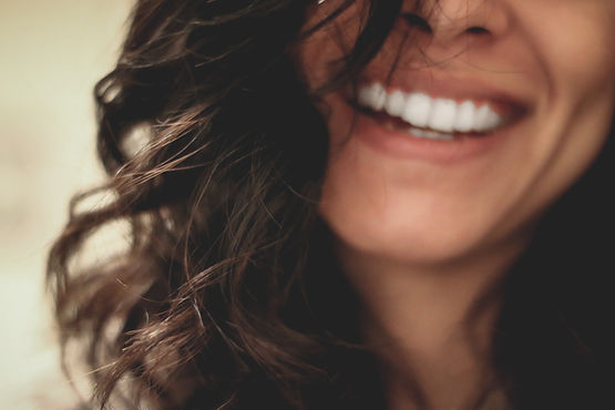 A woman smiling about her new understandings about approaching her emotional eating issues.