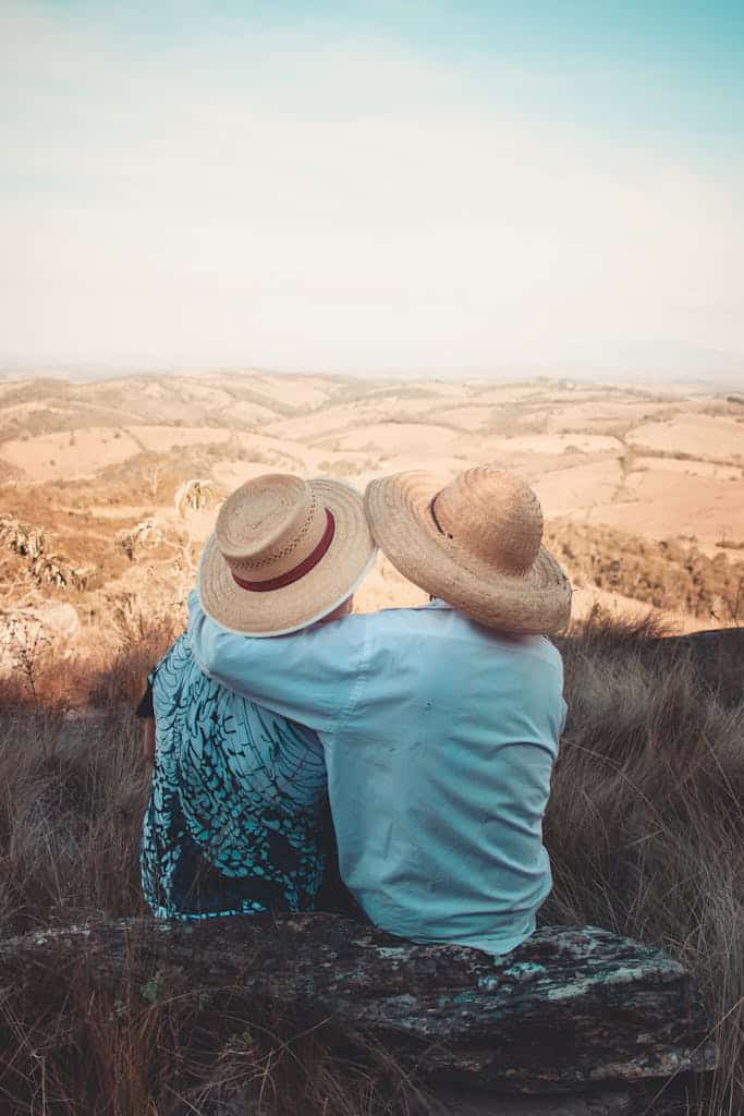 Loving couple embracing while enjoying a scenic view of the Brazilian countryside.